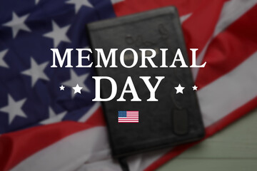Fototapeta na wymiar Text MEMORIAL DAY on blurred USA flag with Bible