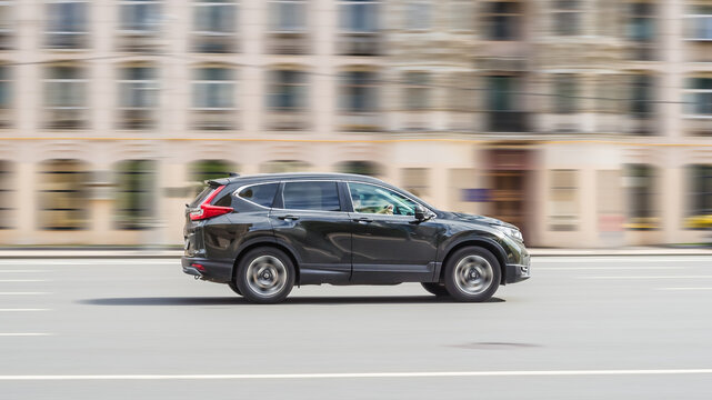 car Honda CR-V Fifth generation Crossover driving along the street in city with blurred background