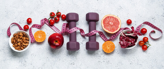 Healthy food, dumbbells and measuring tape on light background. Diet concept