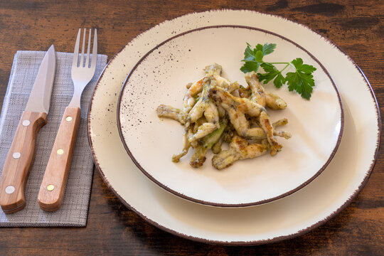 Frog Legs Cooked With Parsley On A Plate, French Cuisine