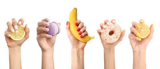 Hands of women with beautiful manicure holding fresh fruits and sweets on white background