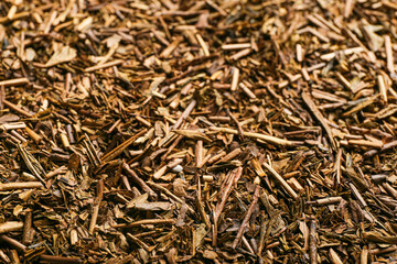 Heap of hojicha green tea as background, closeup
