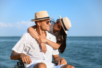 Happy man with physical disability and his girlfriend at sea resort