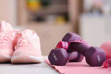 Stylish sport equipment on table in room, closeup