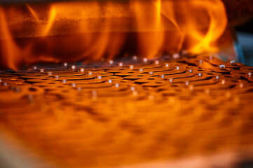 Annealing powdered details with burning flame in furnace - 501451660