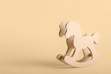 Cardboard rocking horse on beige background