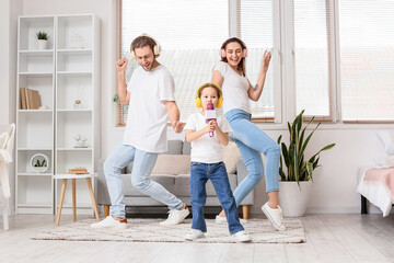 Happy family with headphones and microphone singing song at home