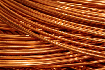 Large bobbin of orange copper wire in light warehouse