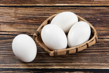 Fresh goose eggs on wooden table