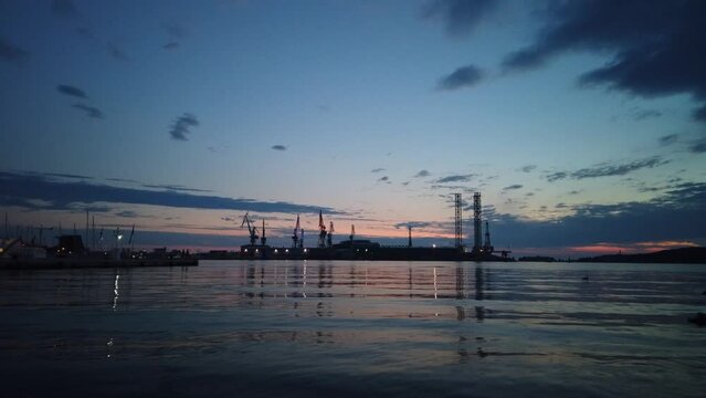 The bankrupt shipyard in Pula. Time lapse of the last lit cranes at nightfall