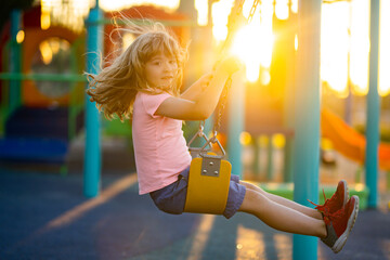 Child boy playing at kids playground. Active little child on playground. Kids play on school or...