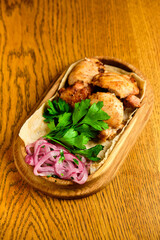 Chicken, Salmon and Meat Shish Kebabs on Parchment with Sauces Top View