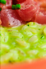 Green Risotto on a white restaurant plate.