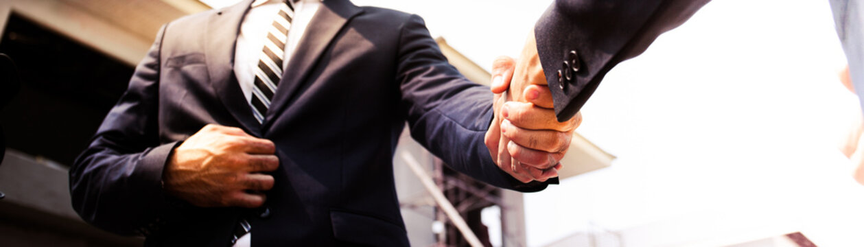 Businessman and businesswoman shaking hands banner 
,business deals congratulations on success Company merger ,negotiationconcept,image panorama for cover design.