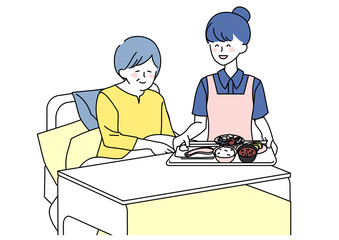 食事を運ぶ介護士女性