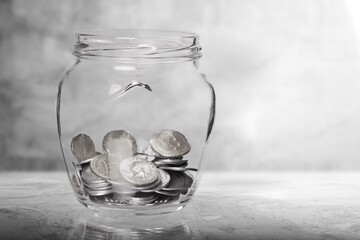 Gold coins on a wooden desk. Money falling concept.