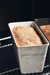 The process of making rye bread. The finished bread is taken out of the oven. Vertical photo.