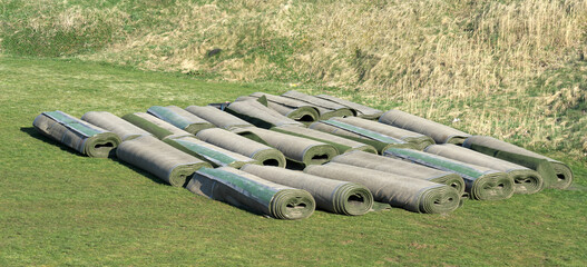 Rolled up used artificial turf when the sport season ended. Selective sharpness.