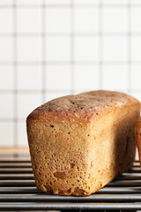 The process of making rye bread. The finished bread is taken out of the oven. Vertical photo.