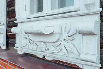 Beautiful old windows. An architectural monument. Old Russian style. Wooden architecture. An old carved frame. Architectural decorative element.