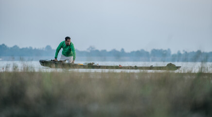 Fisherman use boat to fishing at river in early morning