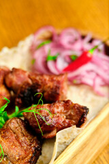 Chicken, Salmon and Meat Shish Kebabs on Parchment with Sauces Top View