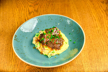 Beef risotto served in a plate with sauce a