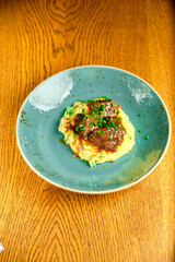 Beef risotto served in a plate with sauce a