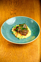 Beef risotto served in a plate with sauce a