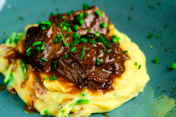 Beef risotto served in a plate with sauce a