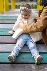 Child education concept. Mom and daughter are playing on the playground.