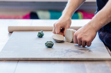 potter, clay workshop, ceramics art concept - male cuts raw clay