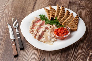 Raw chopped pork lard with meat, a head of garlic and rye bread on a wooden background for copy...