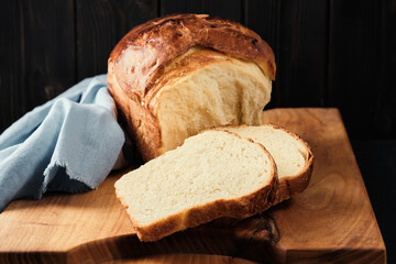 Delicious homemade organic fresh brioche bread on white table. Traditional sweet French brioche, baked concept. Close-up, selective focus