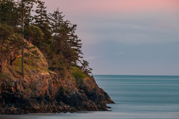 Fototapeta premium A long exposure of a rocky point on San Juan Island overlooking the Haro Straight
