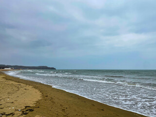 Storm sea with wave and sandy shore