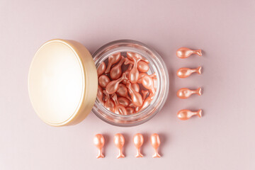 Single-dose serum capsules with active ingredients in a crystal shape container. Skin care and beauty products.