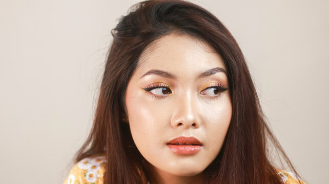 Beautiful young Asian woman wearing makeup isolated with white background. Beauty concept.