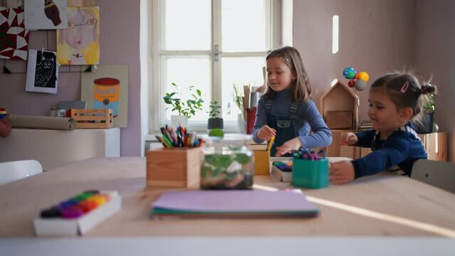 Happy little children preparing for art and craft class indoors at school
