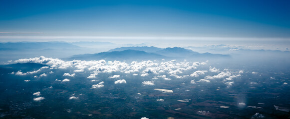 Naklejka na ściany i meble Aerial view of mountains and clouds