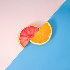 Summer fruit healthy orange and grapefruit party creative concept. Fresh slice on pastel blue and...