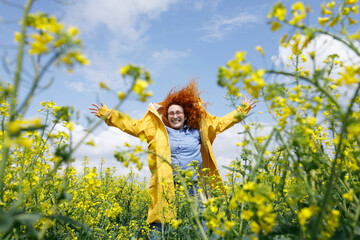 Fototapeta premium Caucasian woman, having fun, jumping, and enjoying her beautiful summer day in nature