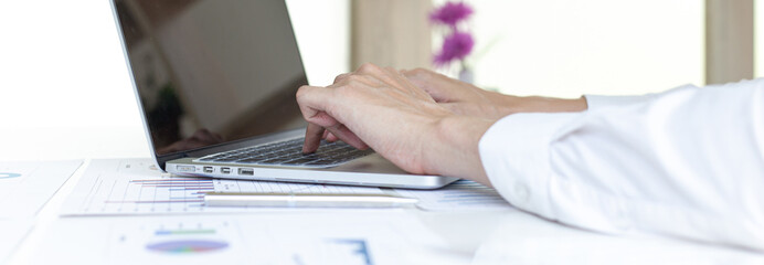 Financial businessmen use laptop to analyze marketing strategies and real estate data to reduce company taxes for their customers, Accounting and Tax concept.