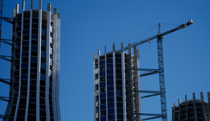 Beautiful residential buildings under construction outdoors and construction crane