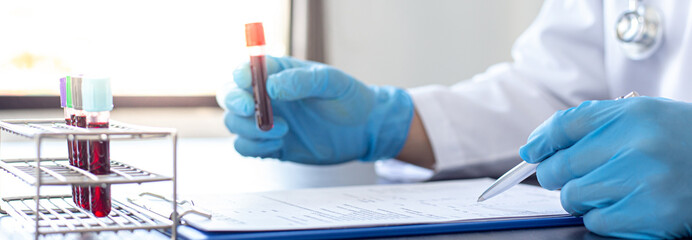 Scientists or physicians analyze the blood sample in vitro to prepare a vaccine against a new strain of viruses, Vaccine Research and Science concept.