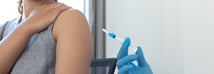 Vaccination of patients, Doctor provided a vaccine with a syringe against a new strain of  virus or...