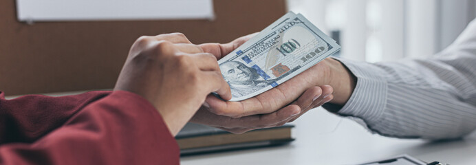 Businessmen give dollars to bribe employees in signing contracts to buy illegal land and real estate, Business fraud and social injustice, corruption and bribery concept.