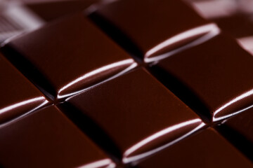 Dark homemade chocolate bars and cocoa pod on wooden