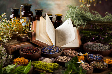 Herbal medicine and book on wooden table background