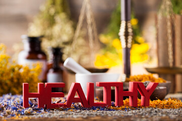 Healthy herbs on wooden table, mortar and herbal medicine